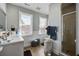 Bright bathroom with tile floors, white shiplap walls, double windows, and a glass enclosed shower at 757 King St, Charleston, SC 29403