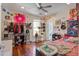 Eclectic bedroom featuring hardwood floors, ample closet space, and natural light from a window at 757 King St, Charleston, SC 29403