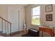 Entryway with hardwood floors, bench, table, mirror, stairs, and a window offering natural light at 757 King St, Charleston, SC 29403