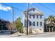 Charming two-story home with light blue siding, lots of windows and stairs to the front door at 757 King St, Charleston, SC 29403
