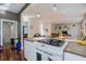 Open kitchen featuring white cabinets, stone countertops, and stainless steel appliances at 757 King St, Charleston, SC 29403