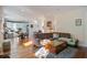 Bright living room featuring hardwood floors that seamlessly flow into the kitchen area at 757 King St, Charleston, SC 29403