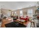Spacious living room featuring hardwood floors, large windows, cozy furniture, and natural light at 757 King St, Charleston, SC 29403