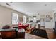 Bright living room featuring hardwood floors, comfortable seating, and an open floorplan with a kitchen at 757 King St, Charleston, SC 29403