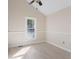 Bright bedroom featuring high ceilings, a ceiling fan, a large window, and wood-look floors at 777 Lake Frances Dr, Charleston, SC 29412