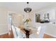 Modern dining room with glass table, elegant chairs and view into another room at 777 Lake Frances Dr, Charleston, SC 29412