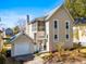 Charming two-story home with a well-manicured yard, garage, and screened porch offers an inviting curb appeal at 777 Lake Frances Dr, Charleston, SC 29412