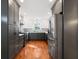 Modern kitchen with two-tone cabinets, stainless steel appliances, and gleaming hardwood floors at 777 Lake Frances Dr, Charleston, SC 29412