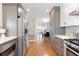 Modern kitchen with stainless steel appliances and gray cabinets, open to the dining area at 777 Lake Frances Dr, Charleston, SC 29412