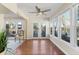 Charming sunroom with floor-to-ceiling windows, water view, ceiling fan and access to the outside at 777 Lake Frances Dr, Charleston, SC 29412