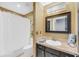 Bathroom showing a shower with white shower curtain, toilet, and vanity with tile countertop and framed mirror at 8 Townpark Ln # B, Charleston, SC 29412