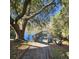 Waterfront property featuring a wooden dock with a canoe on the shore beneath a shade tree at 8 Townpark Ln # B, Charleston, SC 29412