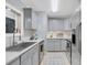 Galley kitchen featuring gray cabinets, light countertops and stainless steel appliances at 8 Townpark Ln # B, Charleston, SC 29412