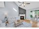 Bright living room features a fireplace, vaulted ceiling, hardwood floors, and backyard access at 8 Townpark Ln # B, Charleston, SC 29412