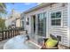 Back patio with sliding glass door access, wood fence, an outdoor table and seating, with string lights at 8 Townpark Ln # B, Charleston, SC 29412