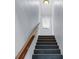 Modern staircase features wooden rails and views of the first floor and backyard at 8 Townpark Ln # B, Charleston, SC 29412