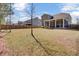 Expansive backyard featuring a well-maintained lawn, screened porch, and wood privacy fence at 808 S Pointe Blvd, Summerville, SC 29483