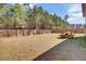 Large, grass-covered backyard with a wooden picnic table and a privacy fence at 808 S Pointe Blvd, Summerville, SC 29483