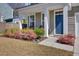 Charming front porch with colorful plants and stylish seating, perfect for relaxing and enjoying the outdoors at 808 S Pointe Blvd, Summerville, SC 29483
