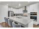 Modern kitchen features white cabinets, stainless steel appliances, and a large center island with seating at 808 S Pointe Blvd, Summerville, SC 29483
