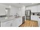 Bright kitchen features stainless steel appliances, a kitchen island with a sink, and pendant lighting at 808 S Pointe Blvd, Summerville, SC 29483