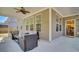 Covered patio with comfortable seating area and ceiling fan, with a view inside at 808 S Pointe Blvd, Summerville, SC 29483