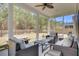 Cozy screened porch with wicker furniture, ceiling fan, and view of the spacious, fenced-in backyard at 808 S Pointe Blvd, Summerville, SC 29483
