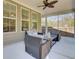 Relaxing screened-in porch featuring comfortable wicker furniture and a stylish ceiling fan at 808 S Pointe Blvd, Summerville, SC 29483