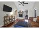 Cozy living room with vaulted ceiling, a fireplace, a ceiling fan, and hardwood floors, perfect for relaxation at 8340 Greenridge Rd, North Charleston, SC 29406