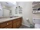 Bathroom featuring a wood vanity, a large mirror, and decorative shelving at 8618 Grassy Oak Trl, North Charleston, SC 29420