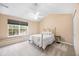 Cozy bedroom featuring neutral colors, a comfortable bed, large window and a ceiling fan at 8618 Grassy Oak Trl, North Charleston, SC 29420