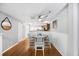Charming dining area with wainscoting, a ceiling fan, and hardwood floors, adjacent to the kitchen at 8618 Grassy Oak Trl, North Charleston, SC 29420