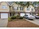 Well-maintained townhome with a one-car garage, manicured landscaping, and ample parking on a concrete driveway at 8618 Grassy Oak Trl, North Charleston, SC 29420