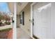 Charming front entrance featuring a white door with black trim and a small porch area at 8618 Grassy Oak Trl, North Charleston, SC 29420