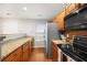 Well-lit kitchen featuring granite countertops, stainless steel appliances, and wooden cabinets at 8618 Grassy Oak Trl, North Charleston, SC 29420