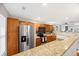 Spacious kitchen featuring wood cabinets, granite countertops, and modern stainless steel appliances at 8618 Grassy Oak Trl, North Charleston, SC 29420