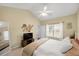 Comfortable bedroom with a ceiling fan, carpeted floors, and large windows for natural light at 8618 Grassy Oak Trl, North Charleston, SC 29420