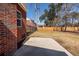 Spacious backyard featuring a concrete patio and a well-maintained lawn with a fence border at 8745 Alexandria Dr, North Charleston, SC 29420