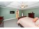 Large bedroom with a TV, ensuite bath and sage green colored walls at 8745 Alexandria Dr, North Charleston, SC 29420