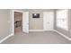 Spacious bedroom with TV, carpet, double doors, closet and window, offering a modern and comfortable space at 8745 Alexandria Dr, North Charleston, SC 29420
