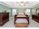 Spacious bedroom with wood floors and tray ceiling, bathed in natural light at 8745 Alexandria Dr, North Charleston, SC 29420