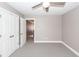 Bedroom with gray carpet, light gray walls, white trim, a ceiling fan and a view to the hallway at 8745 Alexandria Dr, North Charleston, SC 29420