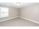 Beige bedroom with neutral carpet and window, offering a clean and simple design at 8745 Alexandria Dr, North Charleston, SC 29420
