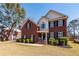 Charming two-story brick home with manicured landscaping, enhancing curb appeal at 8745 Alexandria Dr, North Charleston, SC 29420
