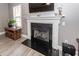 Cozy fireplace with black granite surround and white mantle creating a focal point in the living room at 8745 Alexandria Dr, North Charleston, SC 29420