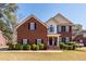 Charming two-story brick home with a manicured lawn and traditional architectural details at 8745 Alexandria Dr, North Charleston, SC 29420