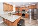 Spacious kitchen featuring wood cabinets, granite countertops, stainless appliances, and hardwood floors at 8745 Alexandria Dr, North Charleston, SC 29420