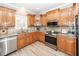Well-equipped kitchen with stainless steel appliances, wood cabinets, and tile backsplash at 8745 Alexandria Dr, North Charleston, SC 29420