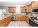 Bright kitchen with stainless steel appliances, wood cabinets, and ample counter space at 8745 Alexandria Dr, North Charleston, SC 29420