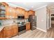 Gourmet kitchen featuring stainless steel appliances, wood cabinets, and granite countertops at 8745 Alexandria Dr, North Charleston, SC 29420
